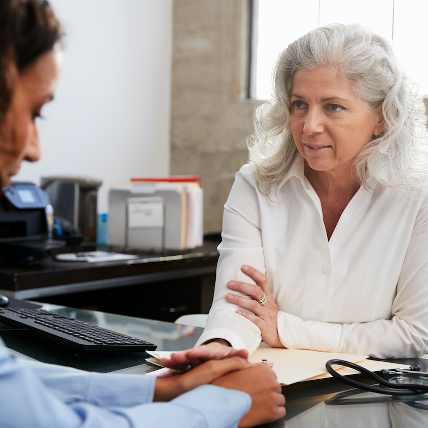 Female doctor reassuring a patient in consultation