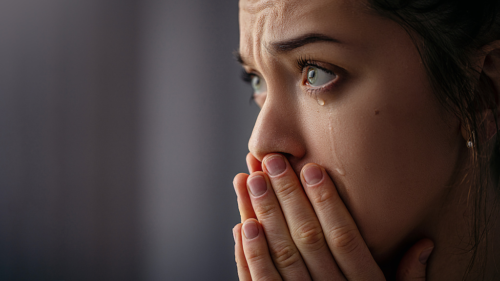 Sad unhappy grieving crying woman with tears eyes closeup Sad unhappy grieving crying woman with tears eyes closeup